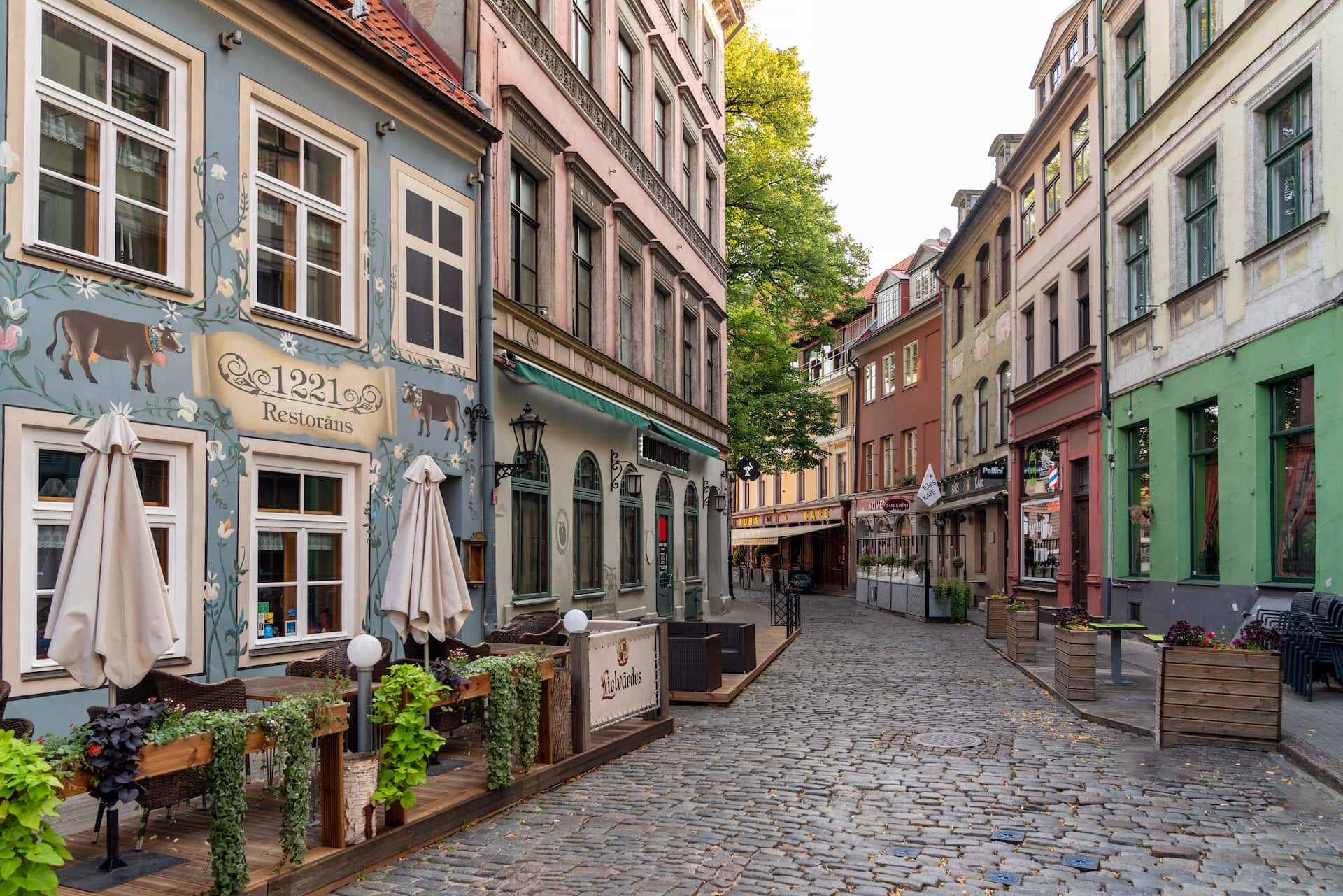 Narrow cobblestone street through Riga Old Town with restored Hanseatic facades